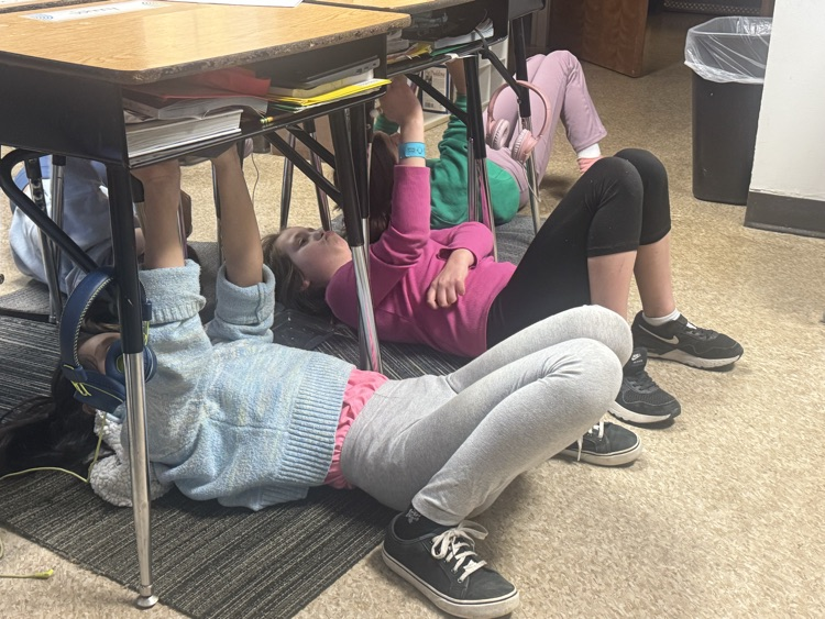 students “painting” under their desks