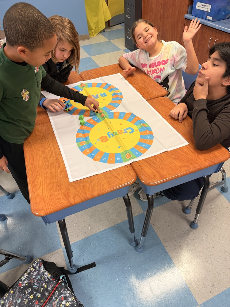 3rd - 5th grade Math Club students playing the Crazy 8’s race! To race around the game board students were decomposing numbers, adding, and reviewing multiples of 8! 