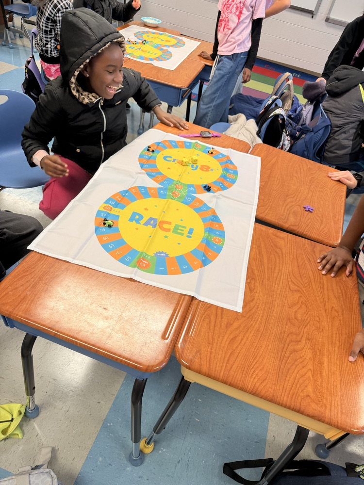 3rd - 5th grade Math Club students playing the Crazy 8’s race! To race around the game board students were decomposing numbers, adding, and reviewing multiples of 8! 