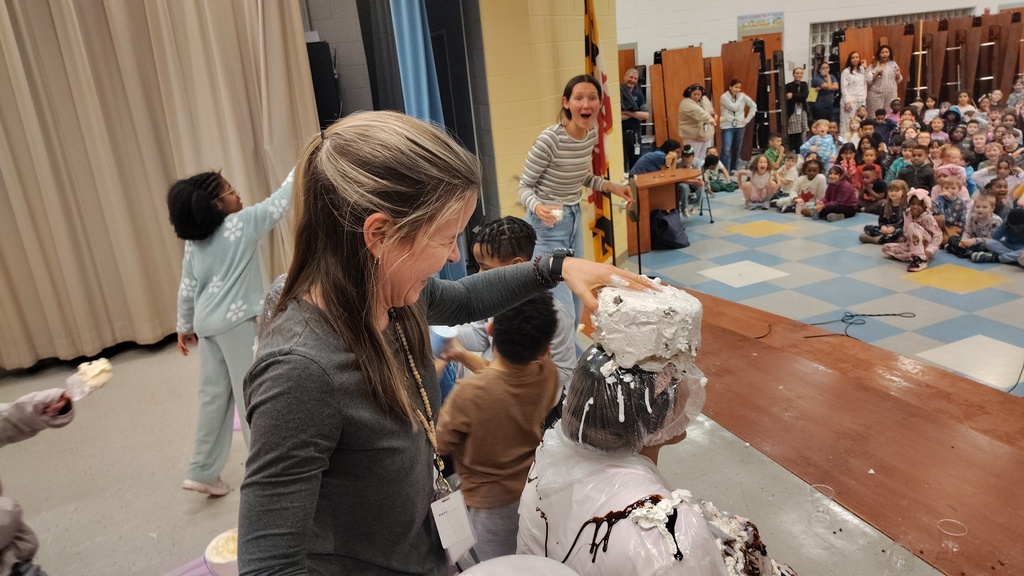 teacher putting ice cream on another teachers head