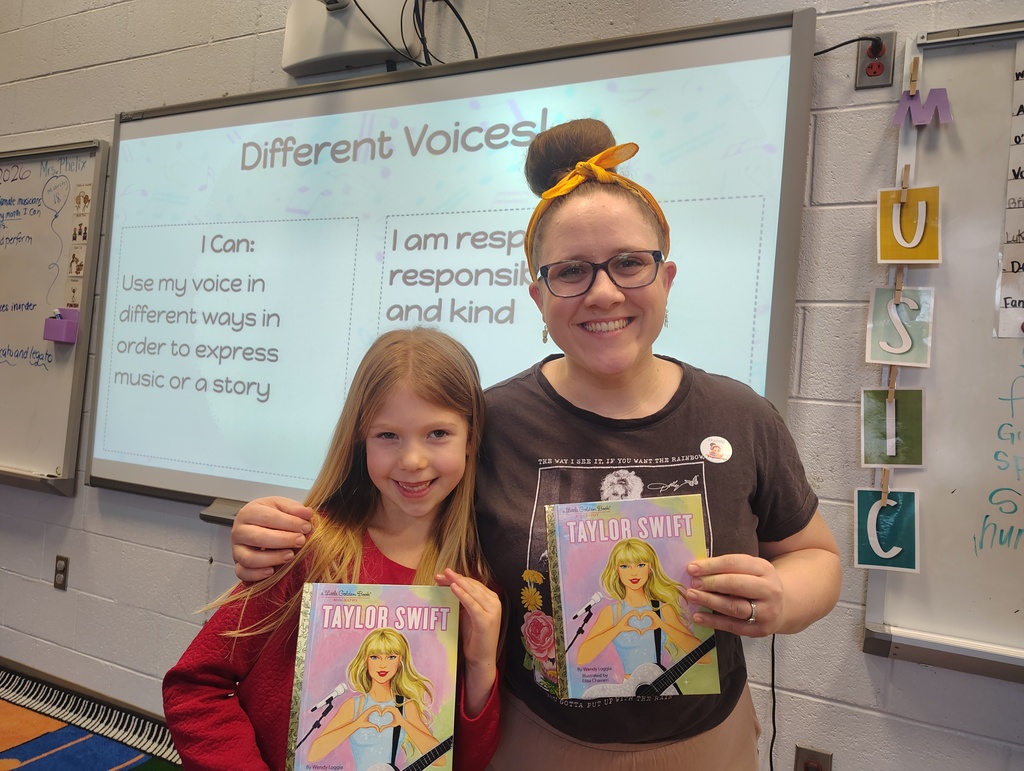 student and teacher with taylor swift book