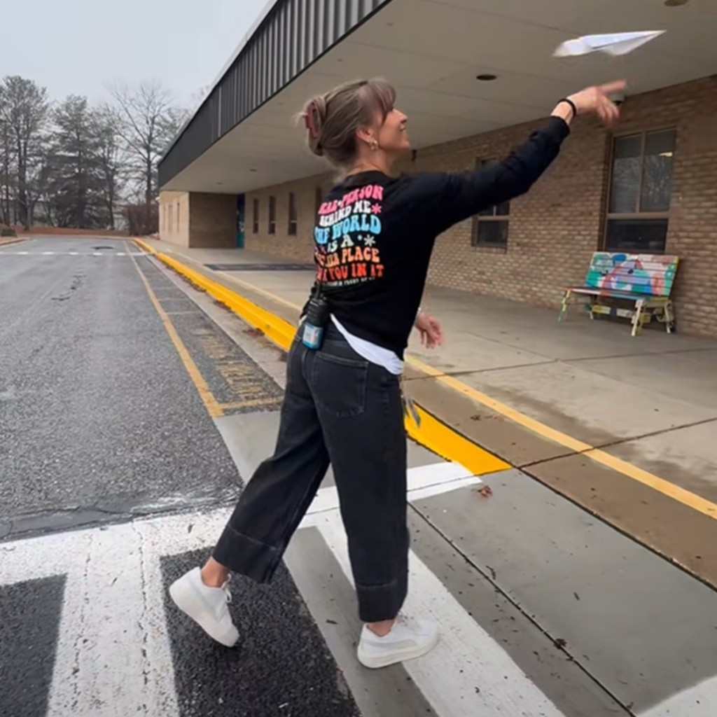 Ruth Parker Eason School Principal Amy Guerke throws a paper airplane