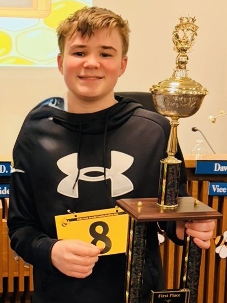 Quint Karlsson Spelling Bee Champion with trophy