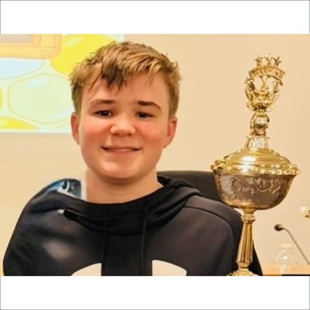 Quint Karlsson Spelling Bee Champion with trophy
