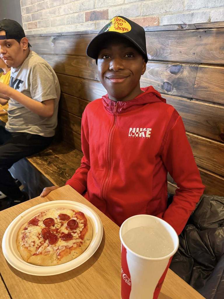 Student with homemade pizza