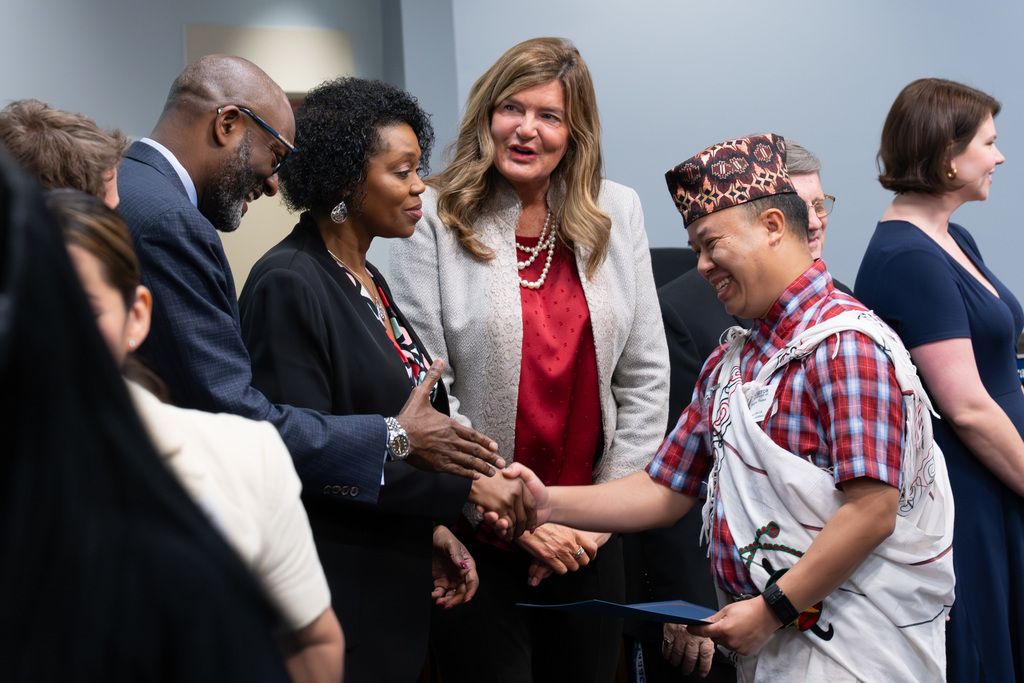 International Parent and Community Leadership Academy graduates are congratulated by the Board of Education