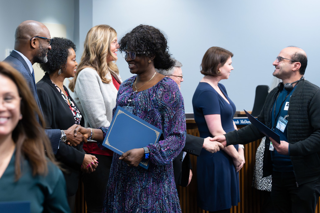 International Parent and Community Leadership Academy graduates are congratulated by the Board of Education
