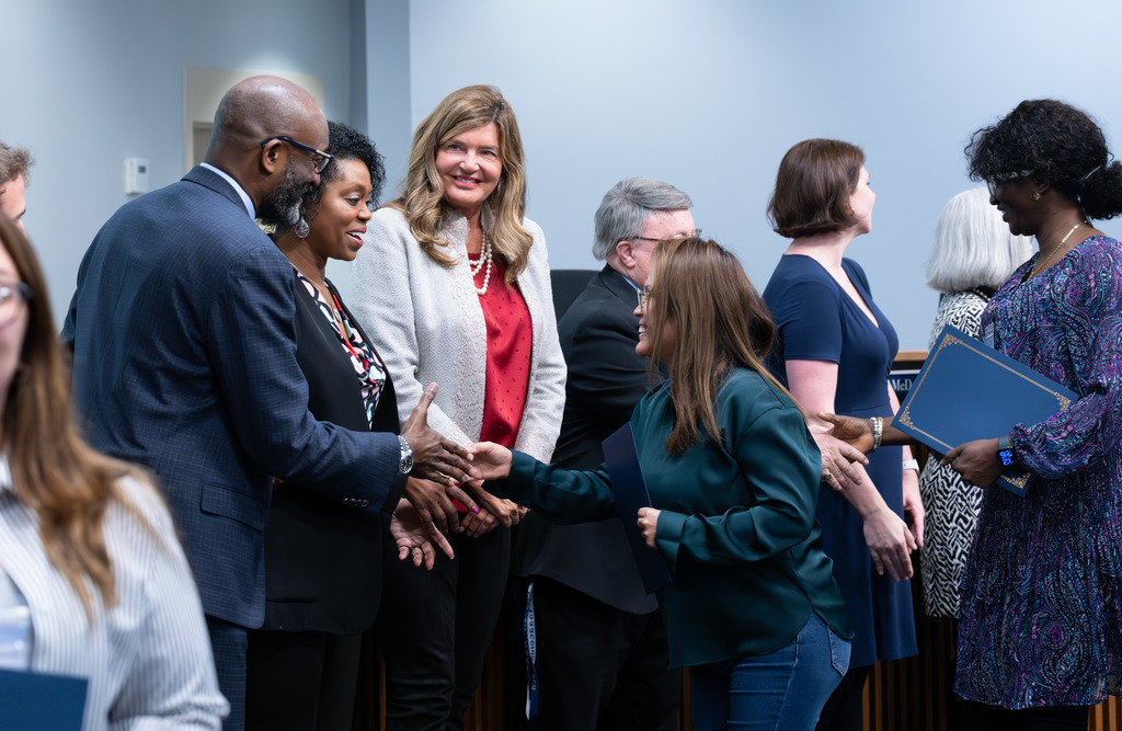 International Parent and Community Leadership Academy graduates are congratulated by the Board of Education