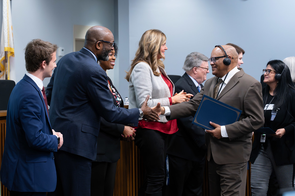 International Parent and Community Leadership Academy graduates are congratulated by the Board of Education