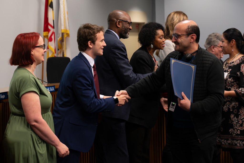 International Parent and Community Leadership Academy graduates are congratulated by the Board of Education