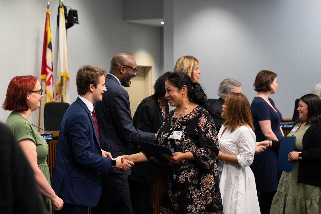 International Parent and Community Leadership Academy graduates are congratulated by the Board of Education