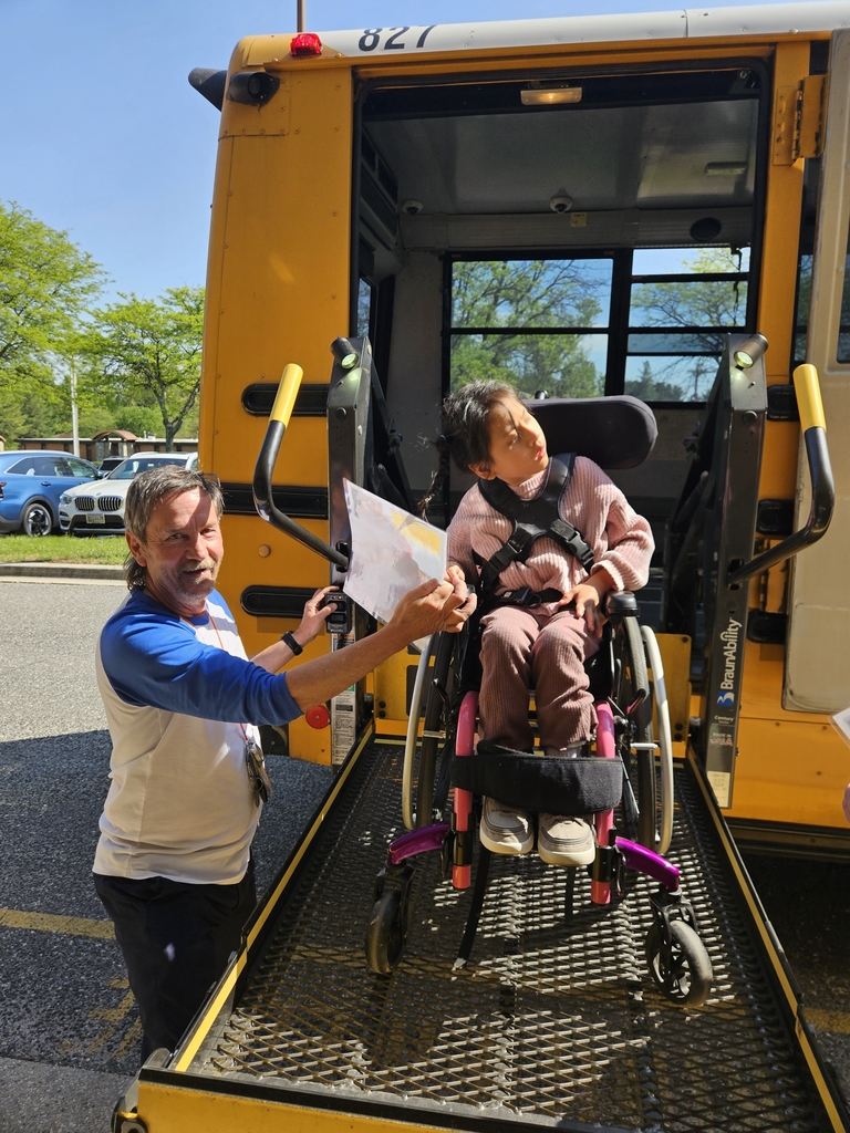 bus driver with student on bus lift