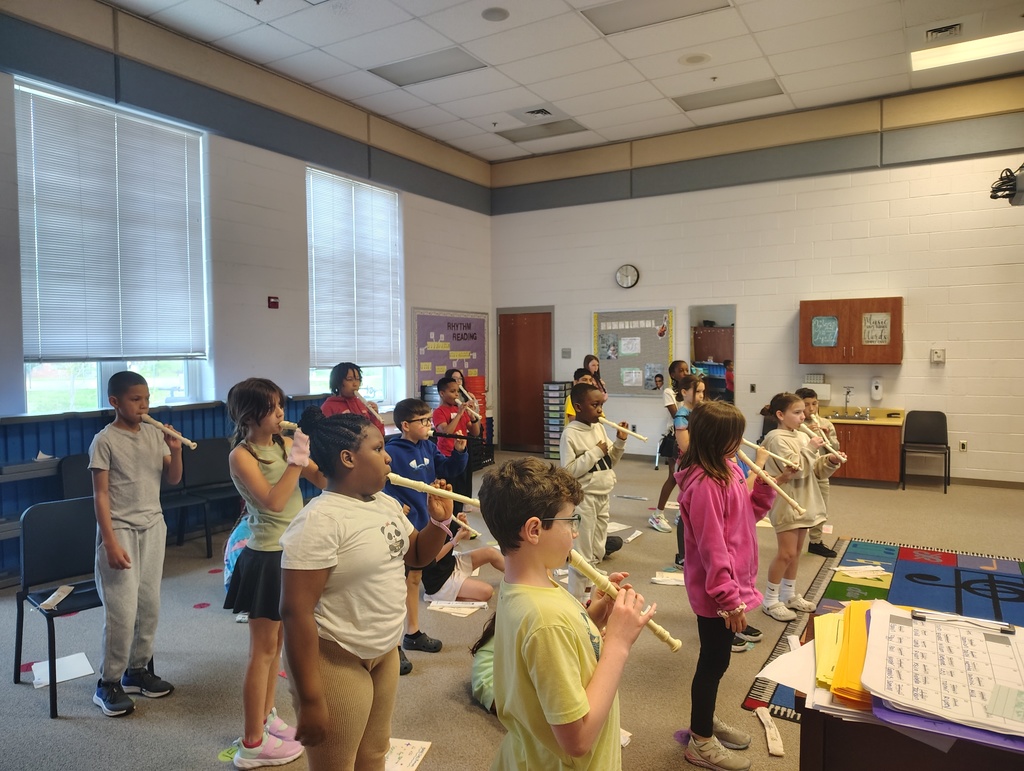 group of students standing and playing recorder