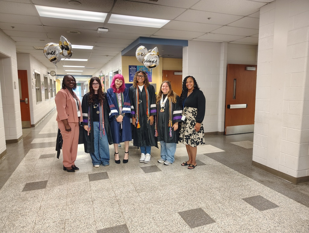 admin and 4 graduates in their gowns