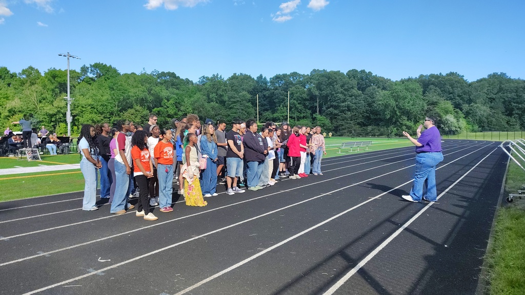 singers standing on a track performing