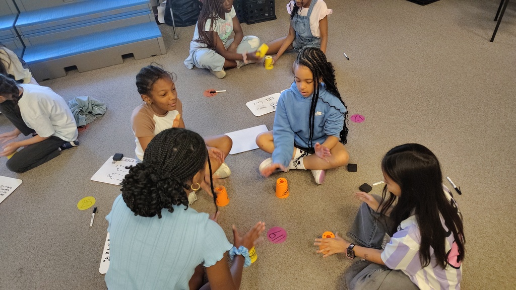 group of girls working together in a circle