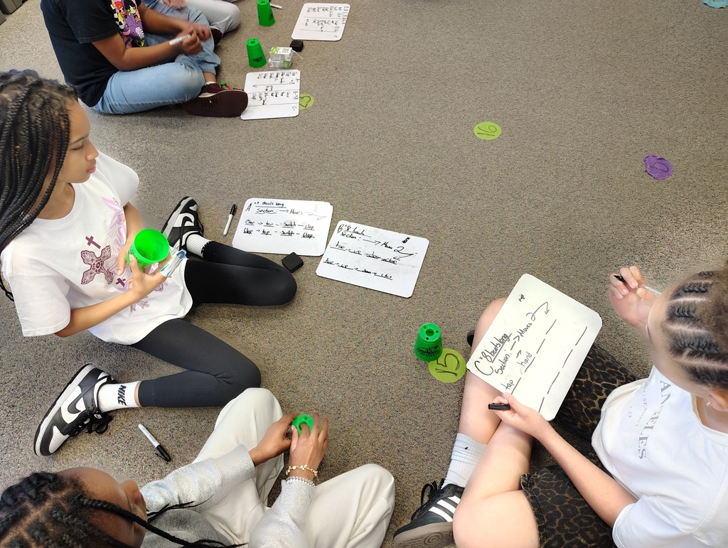 3 girls with white boards and cups