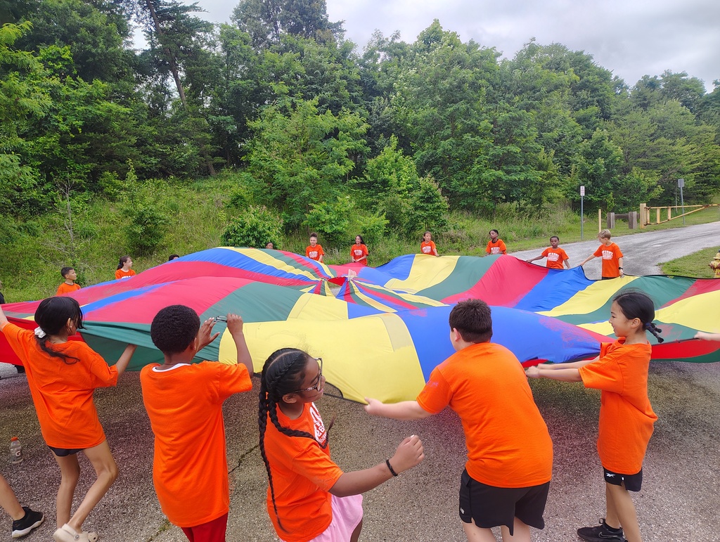 students playing with a parachute