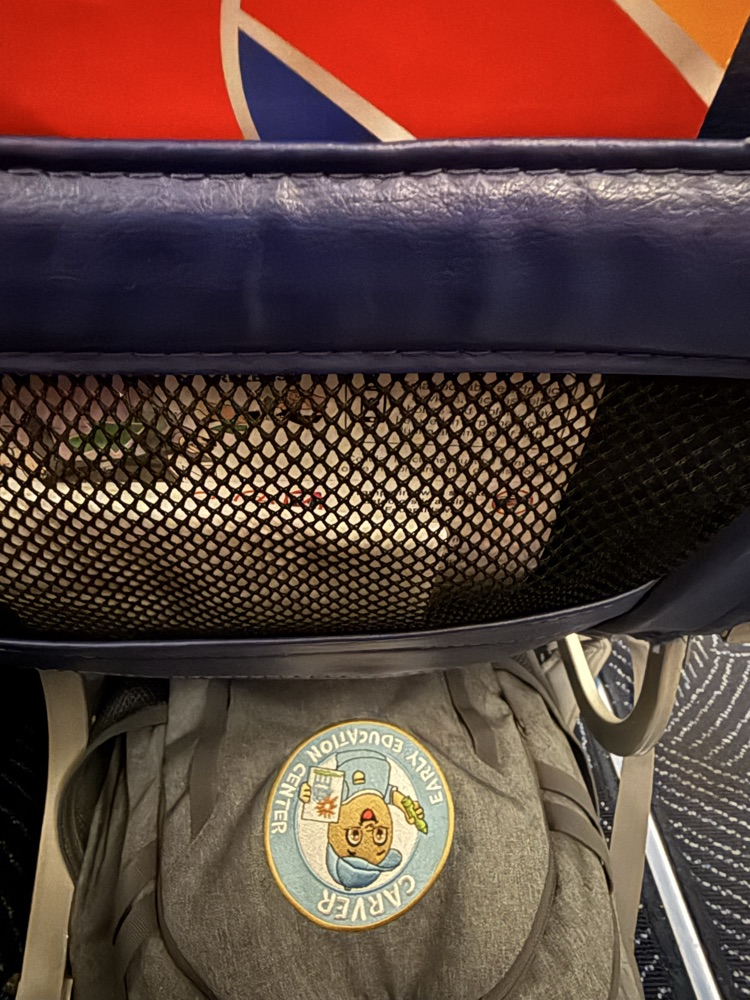 Carver backpack tucked under the seat on a Southwest airplane