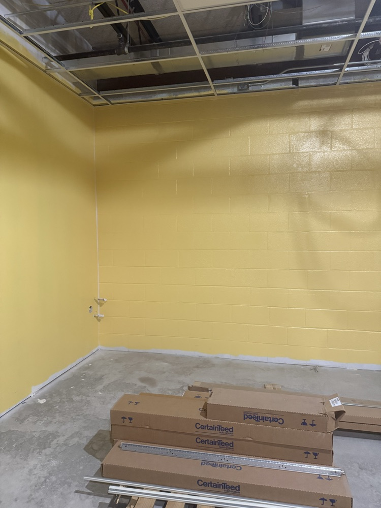 classroom under construction with yellow paint