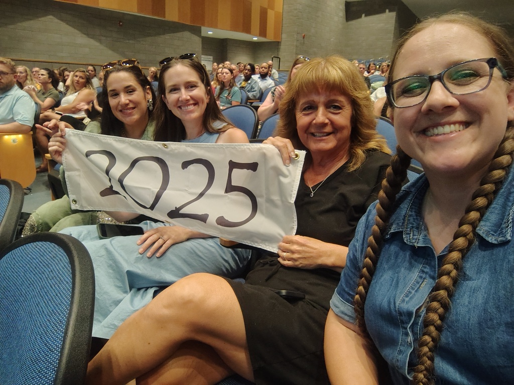 4 female educators with a white banner that says 2025