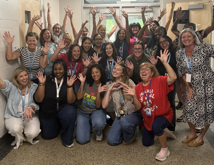 Staff members smiling with excitement and hands in the air
