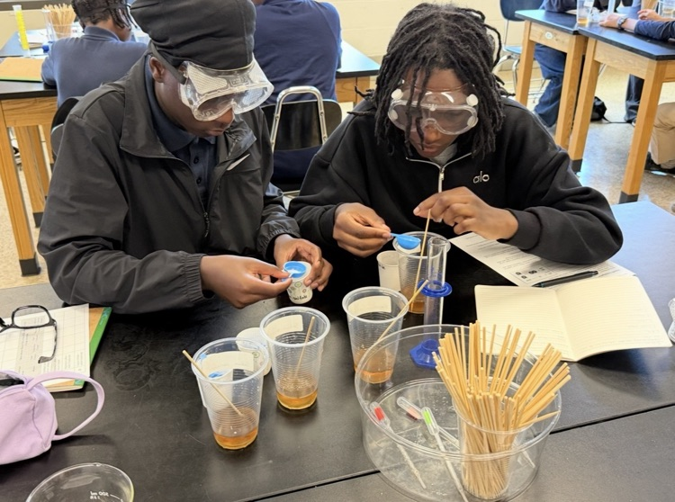 students combining chemicals
