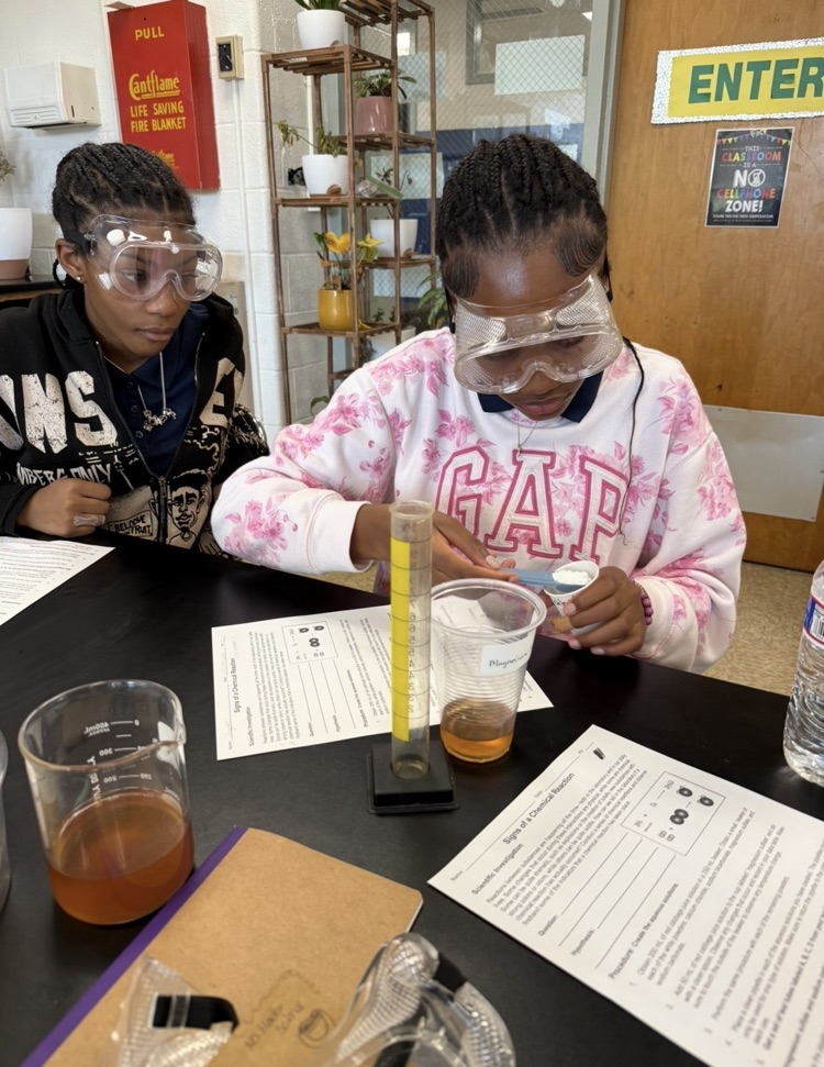 students combining chemicals.