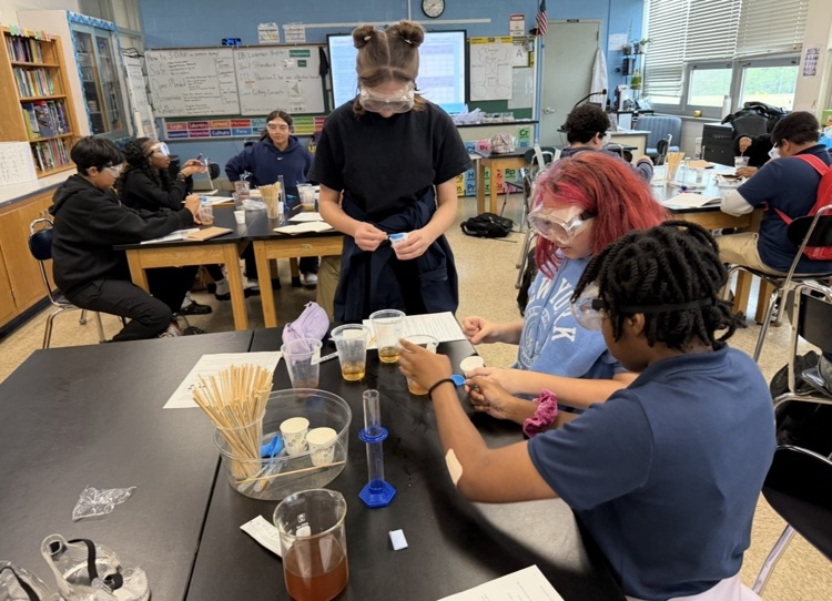 students combining chemicals.