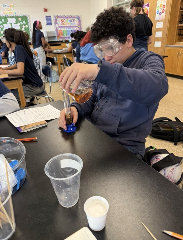 students combining chemicals.