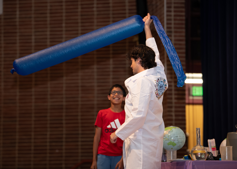 Dr. T of Mad Science DC includes a student participant in a science-themed magic show performance