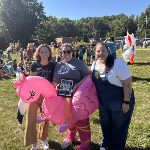 Central Elementary School staff dressed in inflatable flamingo costume holding the school's Best Buddies Best Elementary Chapter in Maryland award