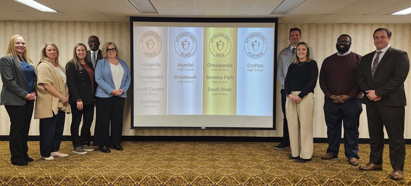 Principals of AP Honor Roll Schools stand in front of awards screen