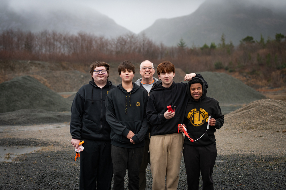 students holding rockets in rock quarry