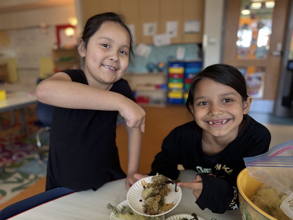 students smiling pointing at herring eggs