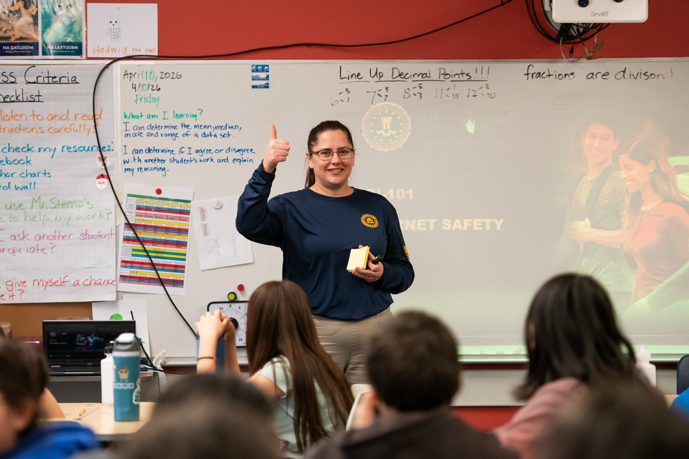 woman giving thumbs up to class