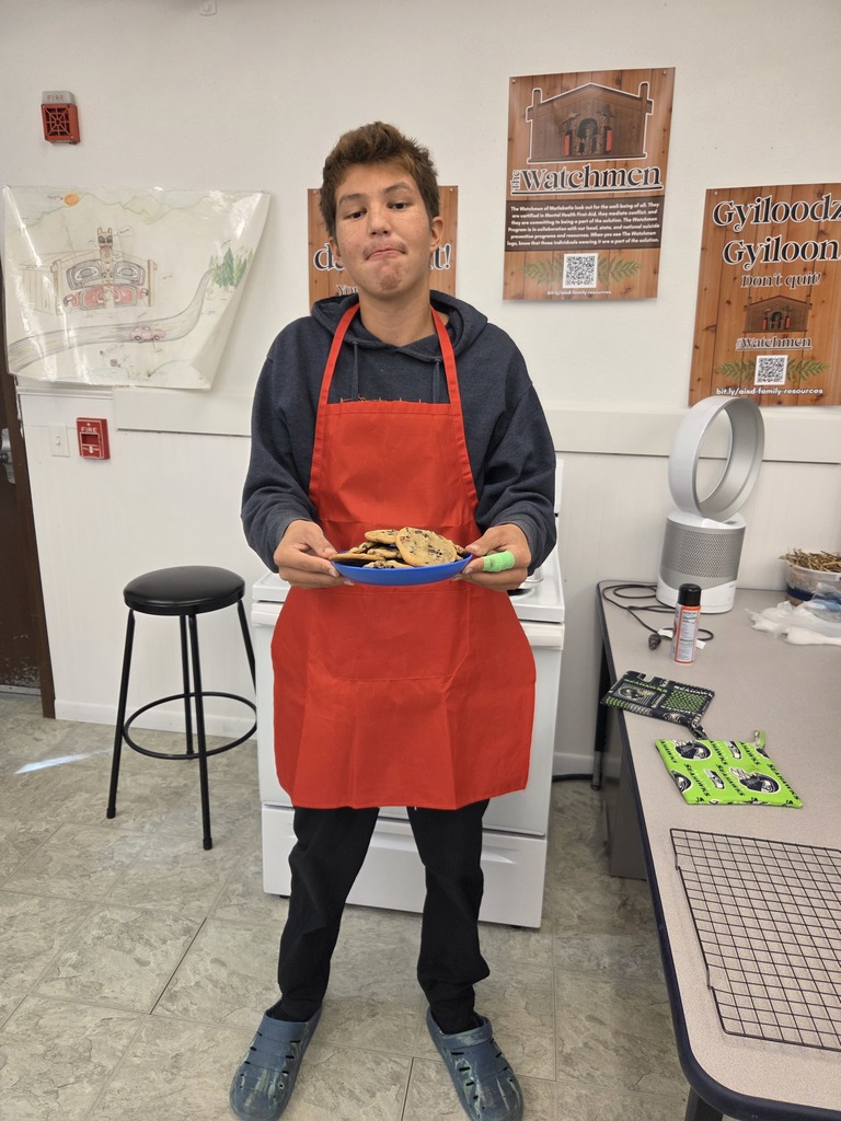 student holding a tray of cookies