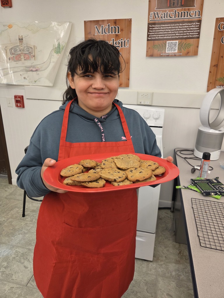 student holding a tray of cookies