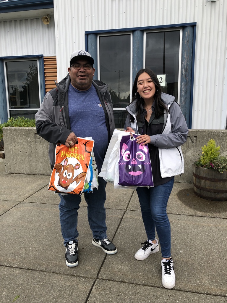 people holding bags of halloween candy