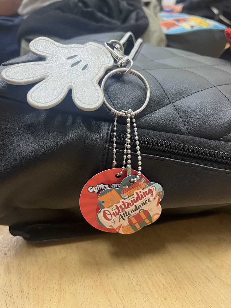 outstanding attendance key chains on black backpack