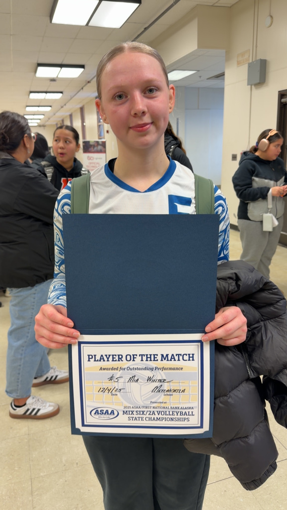 student holding awards