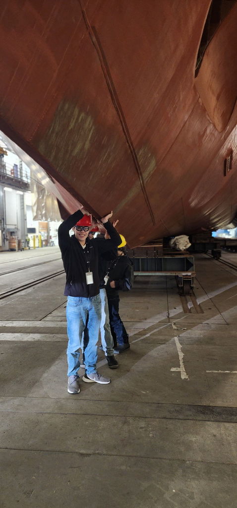 students holding up a ferry
