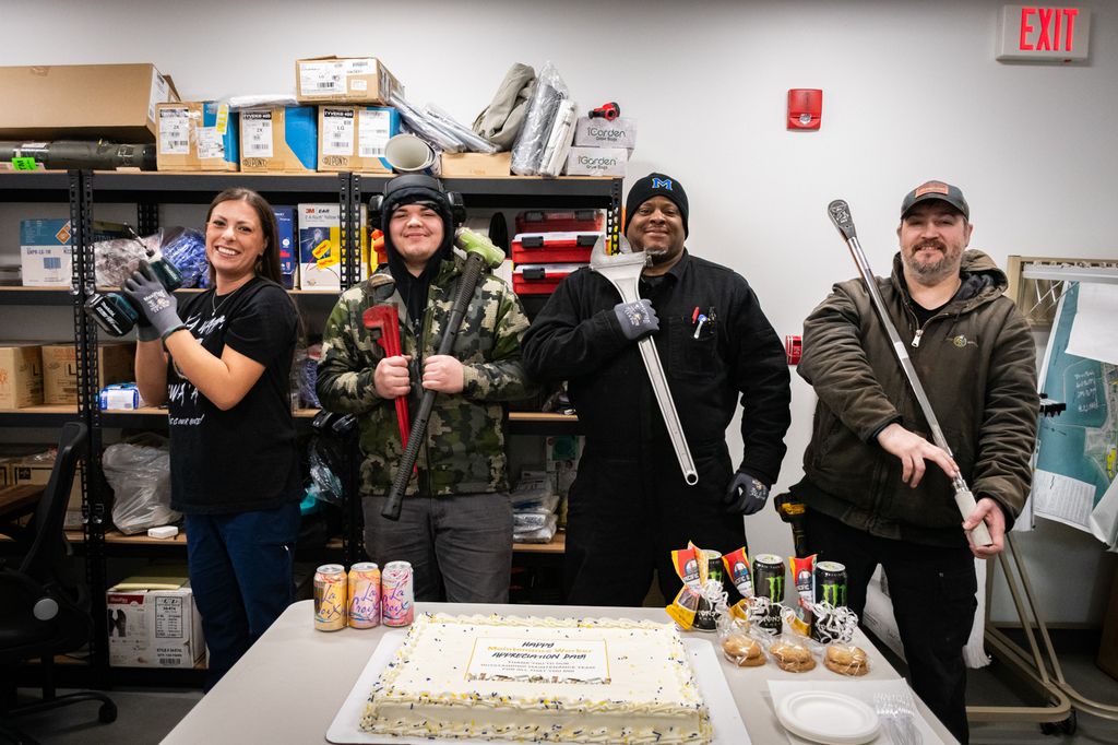 people holding tools with a cake