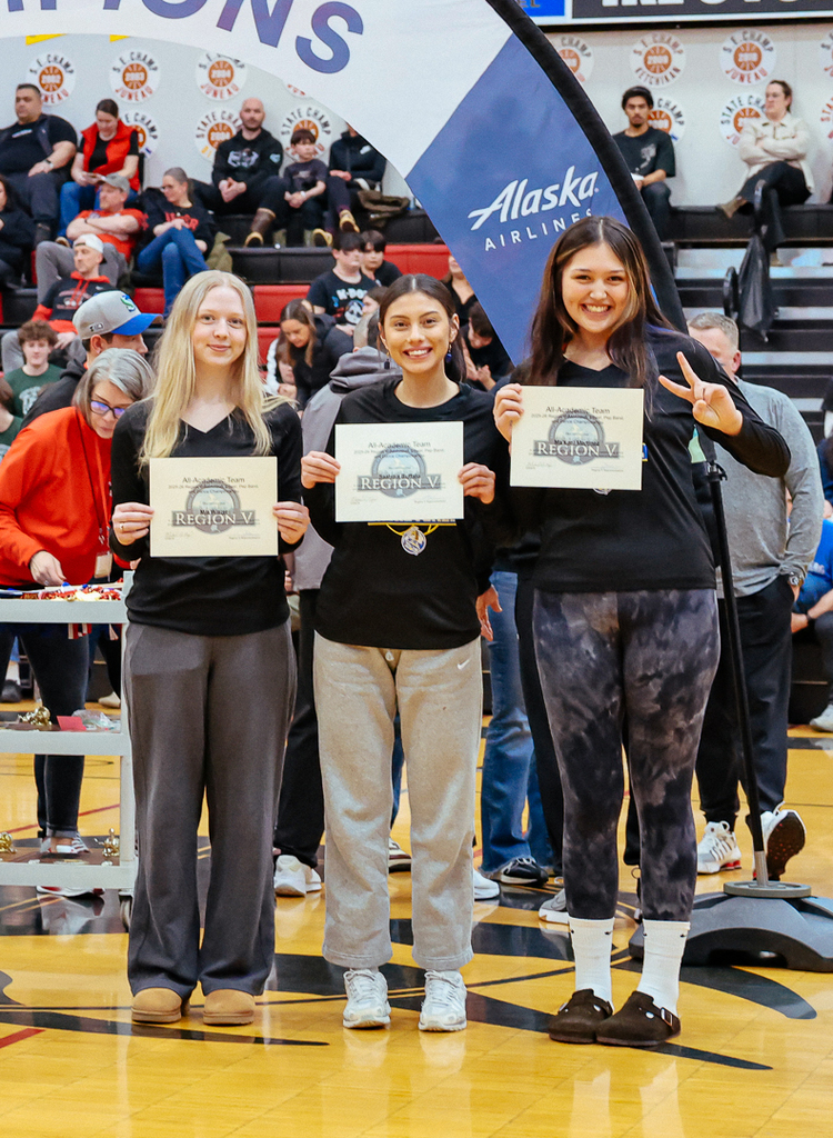 students on basketball court posing