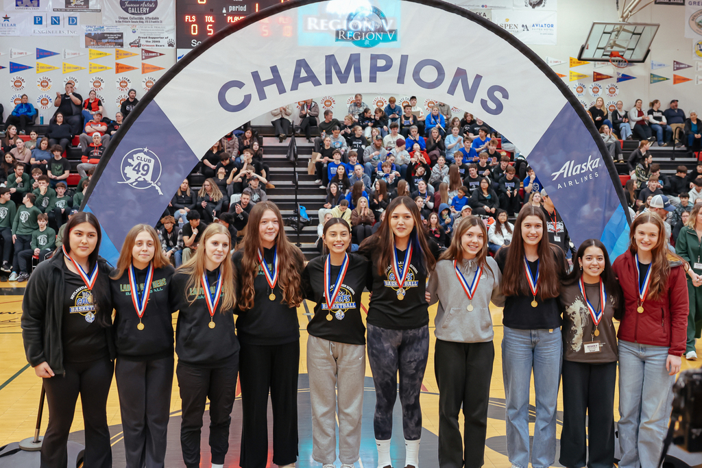 students on basketball court posing