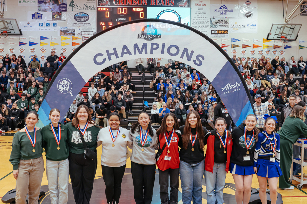 students on basketball court posing