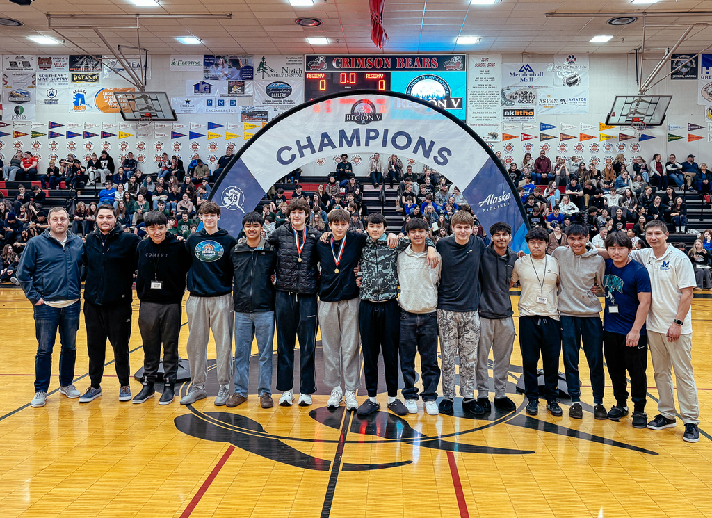 students on basketball court posing