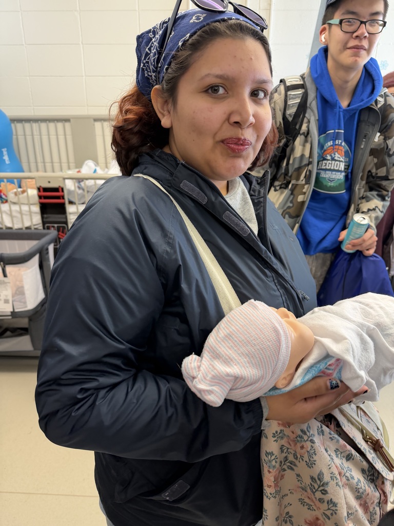 student holding doll
