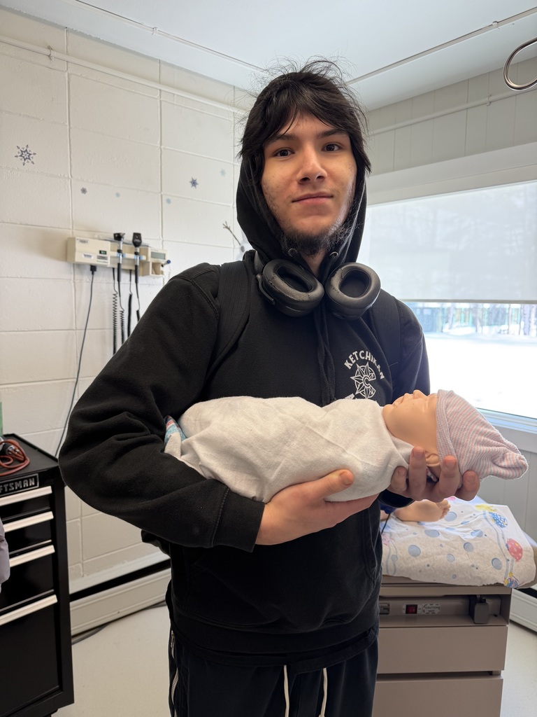 student holding doll