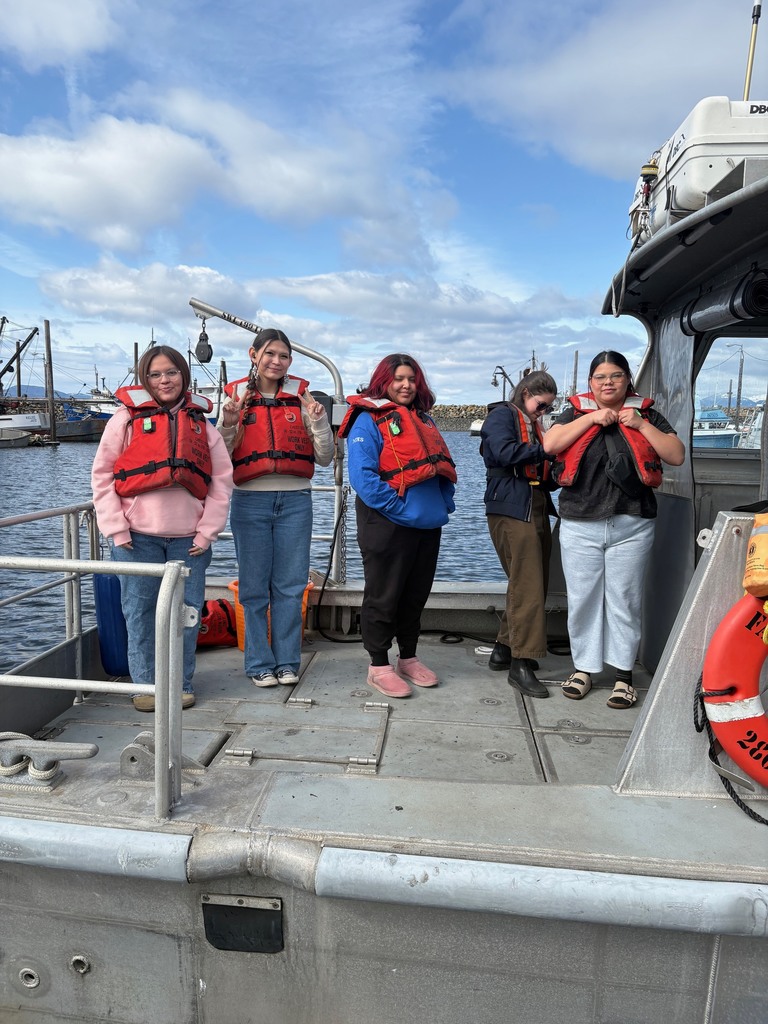 students on a boat in lifejackets